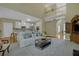 Inviting living room featuring a modern sofa, stylish coffee table, and an open view into the well-equipped kitchen at 840 Milton Oaks Dr, Johns Creek, GA 30022