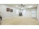 Bright and spacious living room with plush carpet and a modern ceiling fan at 840 Milton Oaks Dr, Johns Creek, GA 30022
