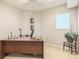 Cozy office with a large wooden desk and a view from the window at 840 Milton Oaks Dr, Johns Creek, GA 30022