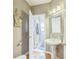 Cozy powder room with pedestal sink, decorative mirror and hardwood floors at 840 Milton Oaks Dr, Johns Creek, GA 30022