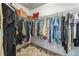 Spacious walk-in closet with wire shelving filled with clothes, shoes and pillows, perfect for organization at 840 Milton Oaks Dr, Johns Creek, GA 30022