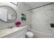 Modern bathroom featuring a shower over the tub, white marble tiling and a large vanity mirror at 2694 Hickory Valley Dr, Snellville, GA 30078
