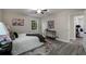 Well-lit bedroom with stylish decor, soft rug, and sleek gray-toned flooring at 2694 Hickory Valley Dr, Snellville, GA 30078