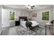 Cozy bedroom with natural light, modern decor, a rug, and sleek gray-toned flooring at 2694 Hickory Valley Dr, Snellville, GA 30078