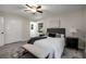 Comfortable bedroom with a gray headboard, bench seat and view of the outdoors through bright, natural light filled windows at 2694 Hickory Valley Dr, Snellville, GA 30078