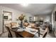 Elegant dining area with a stylish table setting and seamless flow into the living spaces at 2694 Hickory Valley Dr, Snellville, GA 30078