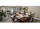 Dining area with wooden table, seating for six, and a view of the adjacent living room at 2694 Hickory Valley Dr, Snellville, GA 30078