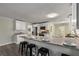Open kitchen with granite countertops, stainless appliances, and breakfast bar with barstool seating at 2694 Hickory Valley Dr, Snellville, GA 30078