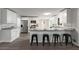 Eat-in kitchen with stainless steel appliances, white cabinets, granite counters, and breakfast bar seating at 2694 Hickory Valley Dr, Snellville, GA 30078