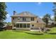 Spacious backyard showcasing the home's exterior, screened porch, and patio at 3055 Dogwood Hollow Ln, Lawrenceville, GA 30043