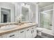 Bright bathroom with double vanity, tile countertops, and glass-enclosed shower at 3055 Dogwood Hollow Ln, Lawrenceville, GA 30043