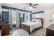 Comfortable bedroom with blue accent wall, wood flooring, and a ceiling fan at 3055 Dogwood Hollow Ln, Lawrenceville, GA 30043