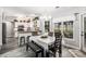 Inviting dining area with a table and bench seating, complemented by natural light from a large window at 3055 Dogwood Hollow Ln, Lawrenceville, GA 30043