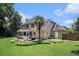 Rear exterior view of a home with a well-manicured yard, patio, and screened porch at 3055 Dogwood Hollow Ln, Lawrenceville, GA 30043