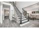 Elegant foyer featuring a staircase with black wrought iron spindles, gray floors, and a welcoming atmosphere at 3055 Dogwood Hollow Ln, Lawrenceville, GA 30043