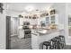 Charming kitchen with white cabinets, stainless steel appliances, a breakfast bar, and stylish gray floors at 3055 Dogwood Hollow Ln, Lawrenceville, GA 30043