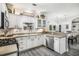 Well-lit kitchen showcases white cabinets, stainless steel appliances, and an open layout leading to the dining area at 3055 Dogwood Hollow Ln, Lawrenceville, GA 30043