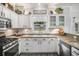 Bright kitchen features white cabinetry, stainless steel appliances, and a window above the sink at 3055 Dogwood Hollow Ln, Lawrenceville, GA 30043