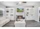 Inviting living room featuring a fireplace with built-in shelving, providing warmth and stylish decor on gray floors at 3055 Dogwood Hollow Ln, Lawrenceville, GA 30043