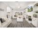 Bright and airy living room with a fireplace, built-in shelving, and stylish gray floors for a cozy retreat at 3055 Dogwood Hollow Ln, Lawrenceville, GA 30043