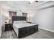 Comfortable main bedroom features a dark wood bed frame, tray ceiling, and coordinating curtains at 3055 Dogwood Hollow Ln, Lawrenceville, GA 30043
