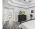 The main bedroom leads to a bathroom with an open door, along with a dresser and wall-mounted television at 3055 Dogwood Hollow Ln, Lawrenceville, GA 30043