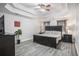 Serene main bedroom boasts a tray ceiling, ceiling fan, and a gray wood-look floor at 3055 Dogwood Hollow Ln, Lawrenceville, GA 30043