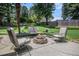 Cozy outdoor patio with stone pavers, furniture, and a fire pit, perfect for relaxation at 3055 Dogwood Hollow Ln, Lawrenceville, GA 30043
