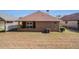 Brick home featuring a well-maintained lawn and outdoor patio, perfect for entertaining at 3264 Salem Cove Se Trl, Conyers, GA 30013