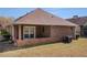 Backyard with brick facade and a small porch at 3264 Salem Cove Se Trl, Conyers, GA 30013