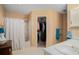 Clean bathroom featuring a shower with white shower curtains and a walk-in closet at 3264 Salem Cove Se Trl, Conyers, GA 30013