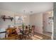 Bright dining room featuring a wooden table set, a chandelier, and a window, creating a warm and inviting space at 3264 Salem Cove Se Trl, Conyers, GA 30013