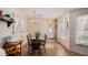 Bright dining room featuring a wooden table set, a chandelier, and a window, creating a warm and inviting space at 3264 Salem Cove Se Trl, Conyers, GA 30013