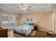 Comfortable bedroom with wood floors, a tray ceiling, and a door to the outside patio, providing a relaxing retreat at 3264 Salem Cove Se Trl, Conyers, GA 30013
