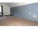 Carpeted attic space with a window, blue paneled wall, and baseboard trim at 5225 Kings Hwy, Douglasville, GA 30135