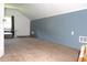 Carpeted attic space with a window, blue paneled wall, and baseboard trim at 5225 Kings Hwy, Douglasville, GA 30135