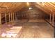 Exposed wood frame attic featuring unfinished flooring, wooden beams, and insulation at 5225 Kings Hwy, Douglasville, GA 30135