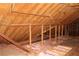 Exposed wood frame attic featuring unfinished flooring, wooden beams, and insulation at 5225 Kings Hwy, Douglasville, GA 30135