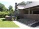 Back of a brick house with elevated patio, metal roof, and landscaped yard at 5225 Kings Hwy, Douglasville, GA 30135