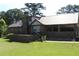 Back angled view of a brick house with an elevated patio, metal roof, and carport at 5225 Kings Hwy, Douglasville, GA 30135