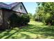Private backyard with green grass, mature trees, and a fenced in area at 5225 Kings Hwy, Douglasville, GA 30135