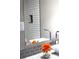 Stylish bathroom mirror reflecting a vessel sink, flowers, and decorative backsplash at 5225 Kings Hwy, Douglasville, GA 30135