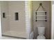 Modern bathroom featuring white subway tile and open shelving above the toilet at 5225 Kings Hwy, Douglasville, GA 30135