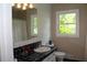 Bathroom features a black tiled counter, white cabinets, and a window with natural light at 5225 Kings Hwy, Douglasville, GA 30135