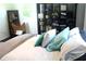 Comfortable bedroom with a bed featuring stylish pillows, modern storage, and a unique chair at 5225 Kings Hwy, Douglasville, GA 30135