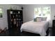 Bedroom with wood flooring, windows, black shelving, and a comfortable bed at 5225 Kings Hwy, Douglasville, GA 30135