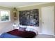 Inviting bedroom featuring a stylish wall art piece, cozy bed, and a window at 5225 Kings Hwy, Douglasville, GA 30135