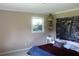 Comfortable bedroom featuring a window, stylish decor, and a cozy bed with colorful accents at 5225 Kings Hwy, Douglasville, GA 30135