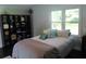 Bright bedroom featuring a large window, comfortable bed, and stylish storage shelves at 5225 Kings Hwy, Douglasville, GA 30135