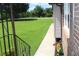 Exterior view from a porch showing a garden bed and lawn under a sunny sky at 5225 Kings Hwy, Douglasville, GA 30135